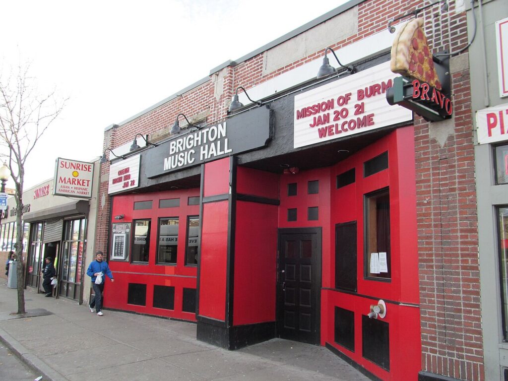 Red-and-black storefront facade and marquee of Brighton Music Hall on Brighton Avenue in Allston