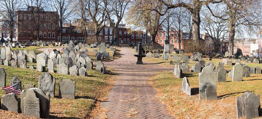 Rows of colonial-era slate headstones along the brick path through Copp's Hill Burying Ground in Boston's North End