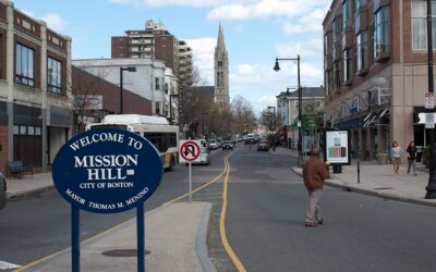 Welcome to Mission Hill sign on Tremont Street in Boston, with the Mission Church spire in the distance — the neighborhood home of Diablo Glass School