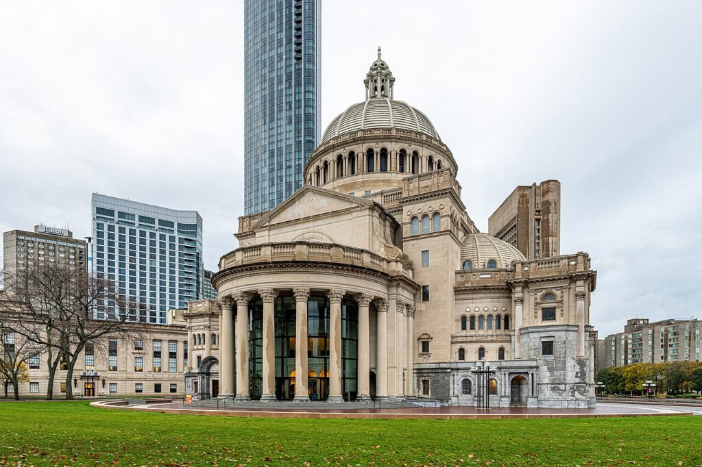Exterior of The First Church of Christ, Scientist (The Mother Church) in Boston, showing the columned portico and grand domed extension on the Christian Science Plaza
