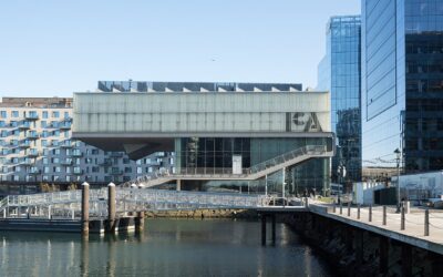 The cantilevered glass-and-steel Institute of Contemporary Art building on the Boston Seaport waterfront, seen from across the water on a clear day
