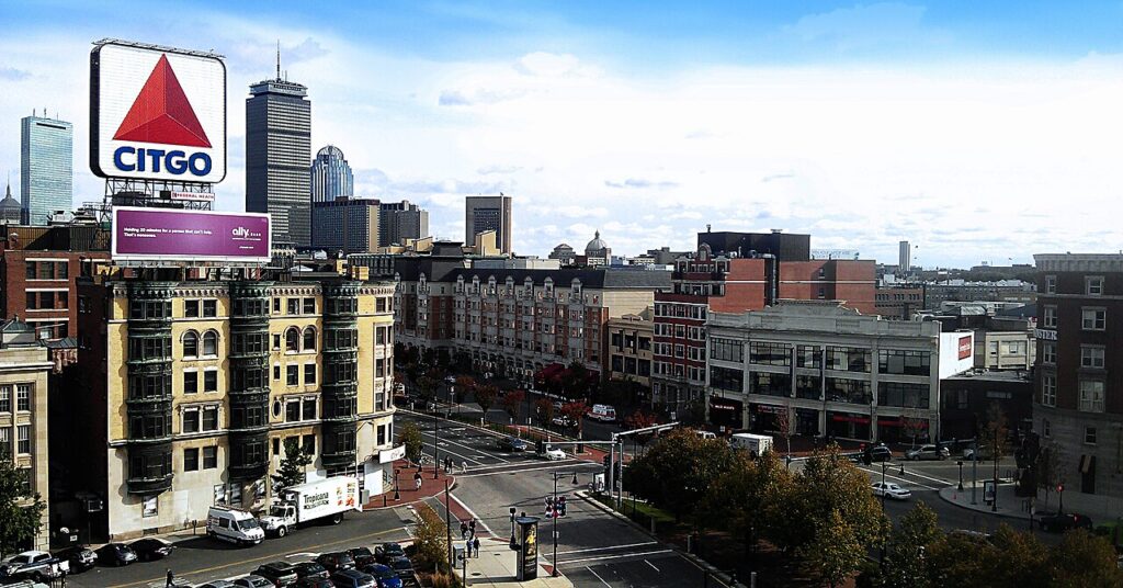 Elevated view of Kenmore Square in Boston on a sunny day with the landmark Citgo sign and the downtown skyline in the distance