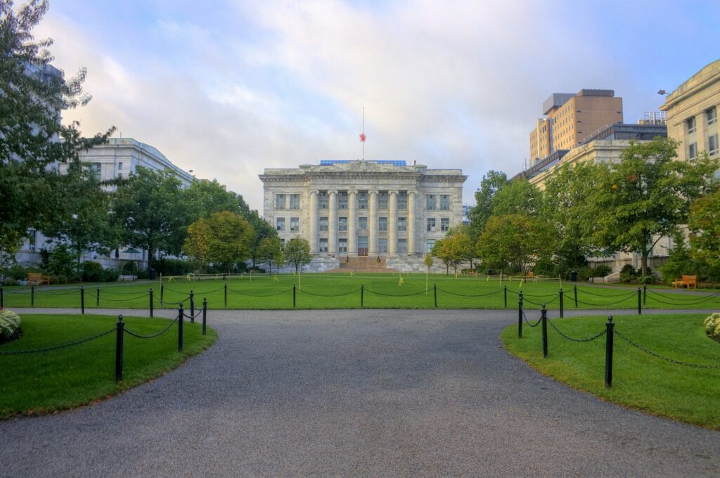 The marble facade of Harvard Medical School across the green quadrangle in the Longwood Medical Area