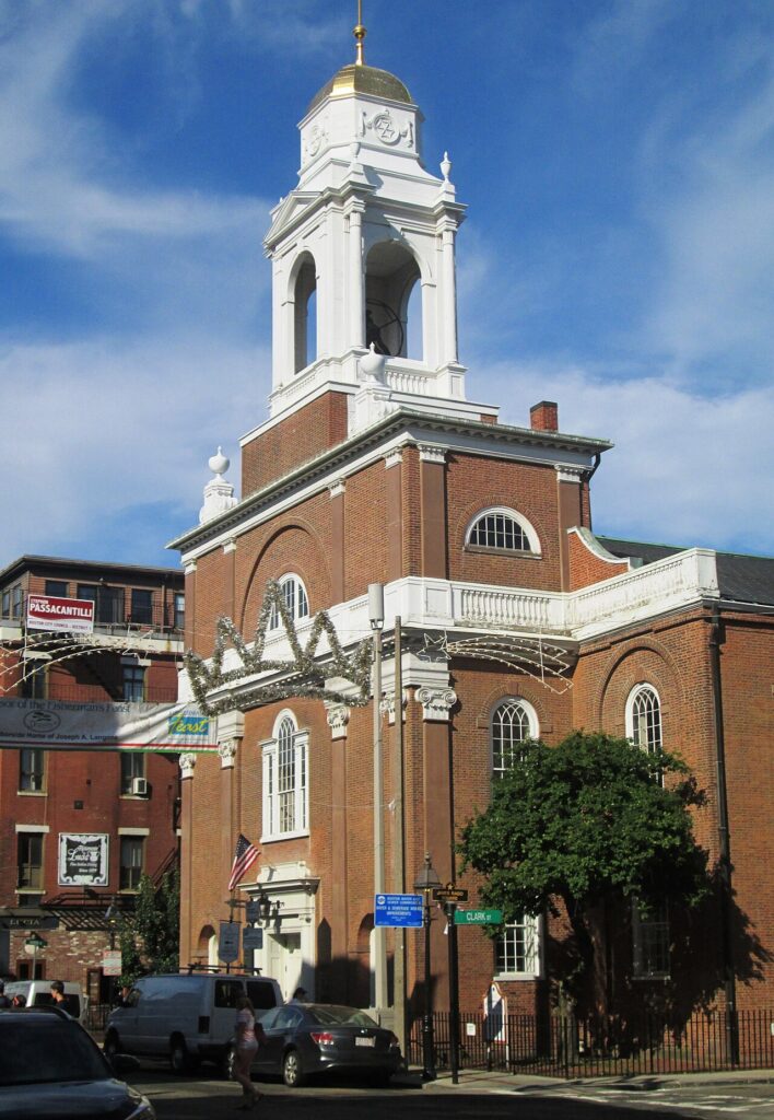 Red-brick facade and white bell tower of St. Stephen's Church on Hanover Street in Boston's North End